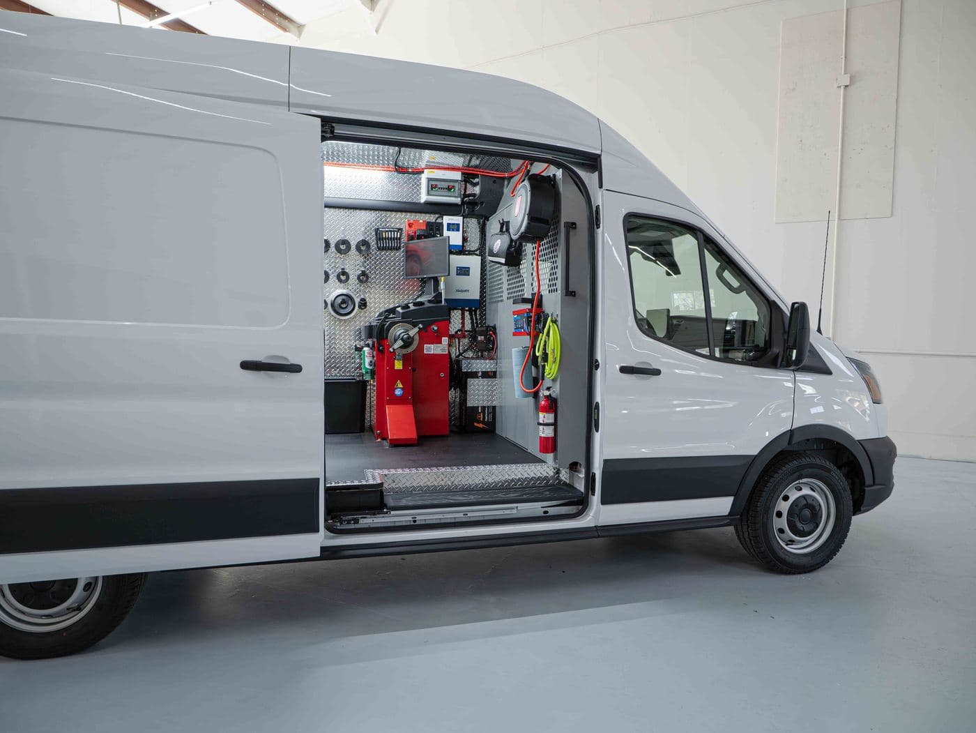 Rear doors open showing storage and racking